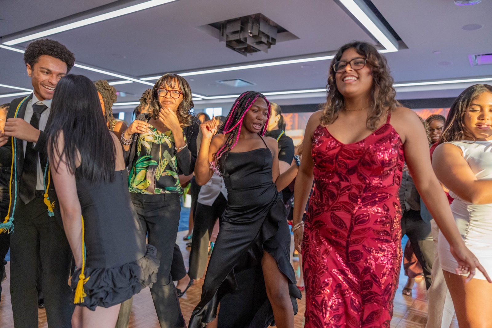 Students dancing and celebrating at a school dance by REmixed Events