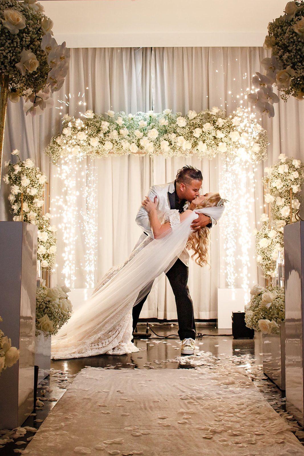 Bride and groom under cold sparks on a Miami Beach wedding dance floor